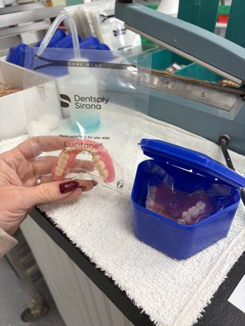 Custom dentures with a Lucitone denture base, finished and ready for delivery.